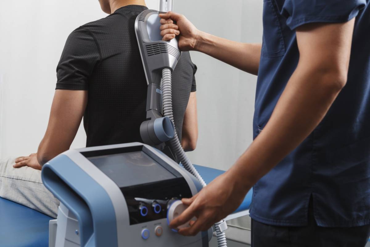 A clinician using a physiotherapy medical device.