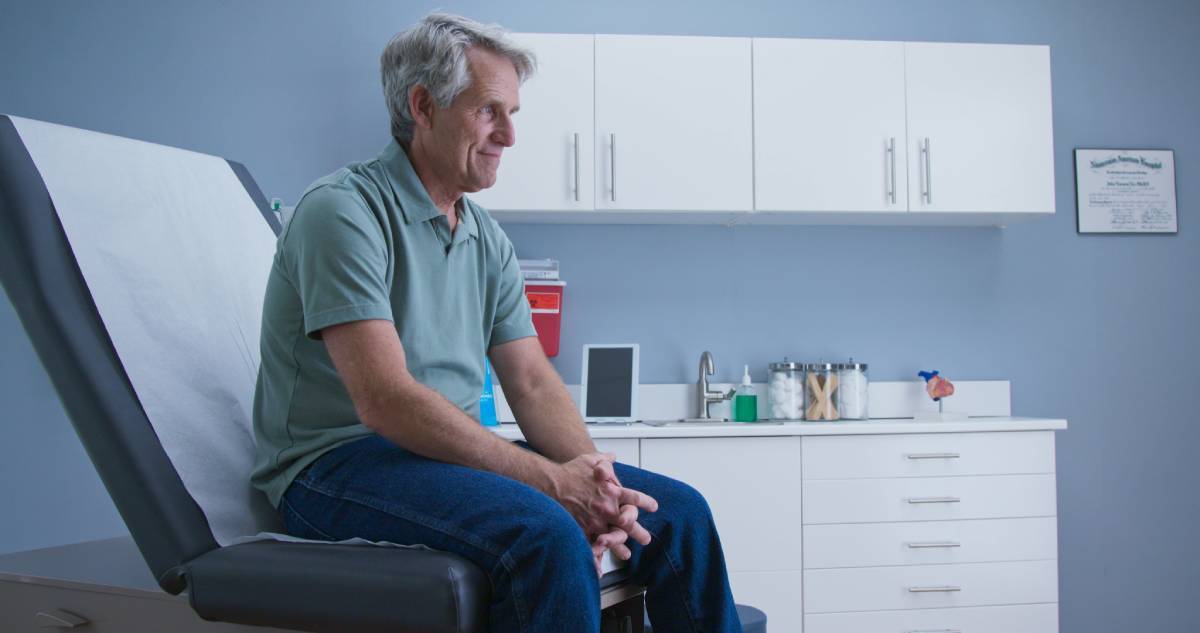 Man waiting for the doctor on a medical exam table