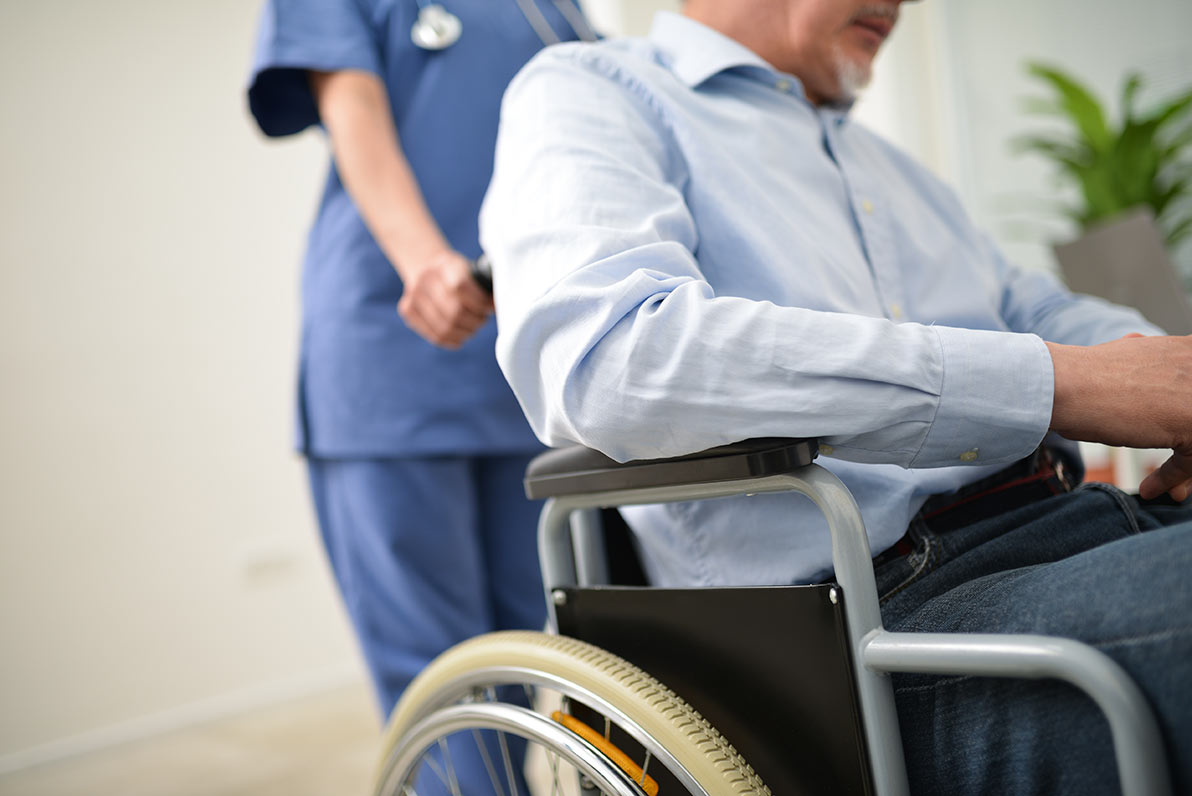 Nurse treating a patient in a wheelchair